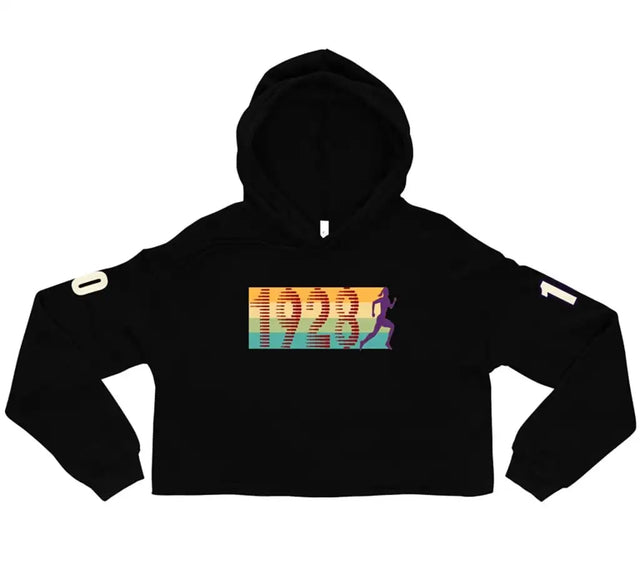 Black cropped hoodie featuring a vibrant rainbow gradient graphic with the number ’1923’’ and a running figure, accented by white patch details on each sleeve.