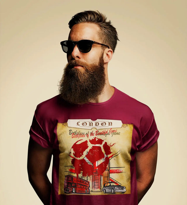 Maroon cotton t-shirt featuring a vintage-style graphic of london with red and beige tones, depicting iconic landmarks like the double-decker bus and classic car beneath text reading ’london birthplace of the beautiful game.’