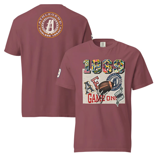 A short-sleeved, crewneck t-shirt in a deep mauve or plum color, featuring a collegiate-style football graphic on the front and a circular logo on the back.
